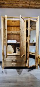 a large wooden bunk bed with open doors at Song Anh Indochina Studios Nguyen Thai Binh in Ho Chi Minh City