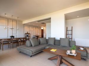 a living room with a couch and a table at Zuzu Riviera Living in Hersonissos