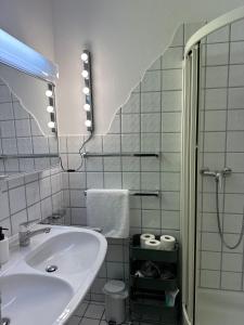 a white bathroom with a sink and a mirror at Appartamento Ascona Vista Lago in Ascona +20 photos