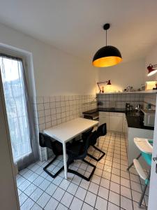 a kitchen with a table and chairs in it at Appartamento Ascona Vista Lago in Ascona