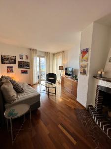 a living room with a couch and a fireplace at Appartamento Ascona Vista Lago in Ascona