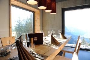 a dining room with a long table with glasses at Berghotel Mettmen in Schwanden +24 photos