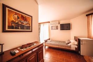 a living room with a couch and a refrigerator at Guest house Šebelj in Budva