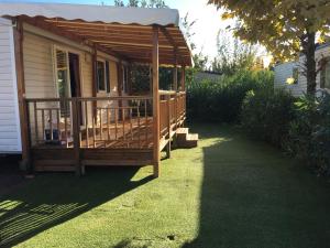 a wooden gazebo in the yard of a house at Location mobile home 6 personnes a fréjus in Fréjus
