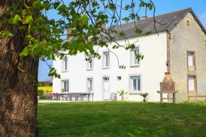 a large white house with a table and a bell at Crazy Villa Gilliere 61 - Heated pool - Basket - 2h Paris - 30p in Montchevrel