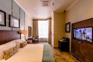 a hotel room with a bed and a flat screen tv at Gold Reef City Theme Park Hotel in Johannesburg