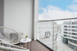 a balcony with a view of a building at Plac Unii Apartment Gdynia by Renters in Gdynia