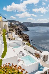 a view of the amalfi coast from a house with a swimming pool at Aristos Life Luxury Cave Villas in Oia