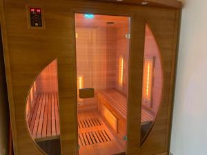 a small sauna with a mirror in a room at Maison entière avec sauna privatif Sauna sur Sye in Aouste-sur-Sye