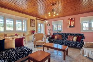 a living room with couches and a table at Villa Roxa Montuoso in Agios Leon