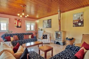 a living room with couches and a fireplace at Villa Roxa Montuoso in Agios Leon