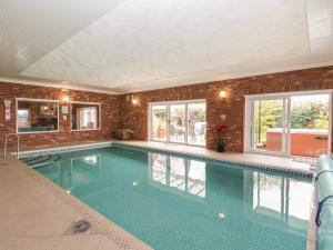 a large swimming pool in a house at Walnut House in Lowestoft