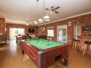 a living room with a pool table in it at Walnut House in Lowestoft
