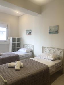 a bedroom with two beds and a window at Seaside Villa in Preveza