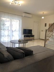 a living room with a couch and a table at Seaside Villa in Preveza
