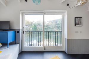 a room with a sliding glass door with a balcony at Deep Lock Studio in Bath