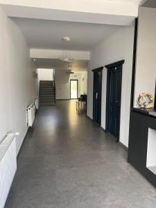 an empty hallway of a building with a staircase at Pensiunea Mountain Pearl in Deseşti
