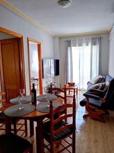 sala de estar con mesa, sillas y sofá en Apartament Violetta, en Torrevieja