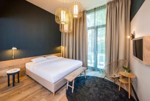 a hotel room with a bed and a tv at Hotel Arena in Amsterdam