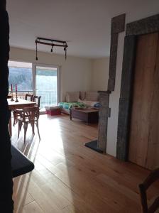 a living room with a table and a fireplace at le gîte des remparts in Aywaille