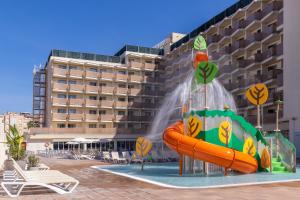 a water slide in front of a hotel at htop Amatista #htopBliss in Lloret de Mar