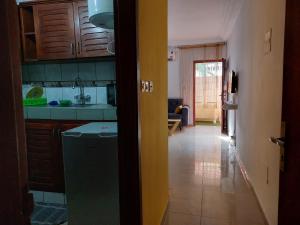 a kitchen with a refrigerator and a counter top at REV Residence in Abidjan
