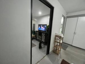 a mirror reflection of a living room with a television at One Bedroom Condo Subic Bay in Morong