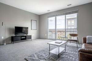 a living room with a couch and a tv at Santana Row 2br townhouse w pool nr highways SFO-1327 in San Jose