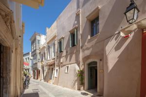 an alley in an old town with a bike on the sidewalk at DOMUS CLODIA, sensing Rethymno's Old Town! in Rethymno Town
