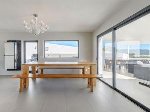 a dining room with a bench and a dining table at Modern Villa with sea views in Sant Josep de sa Talaia