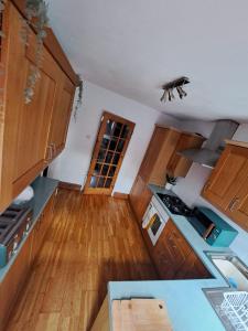 a kitchen with wooden cabinets and a counter top at Boutique Abode - With Hot Tub in Chester