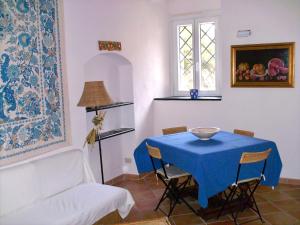 a dining room with a blue table and chairs at Casa del 1400 nell'antico Borgo di Cervo in Cervo