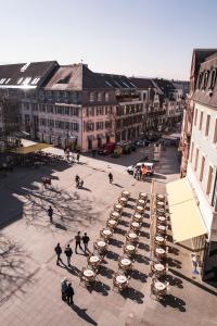 a group of cars parked in a courtyard in a city at BASE II - Das Bed & Breakfast bei Basel (Lörrach) in Lörrach
