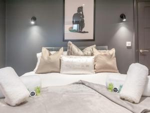 a bedroom with a white bed with pillows at Pass the Keys Luxurious Retreat with Workspace in Leeds