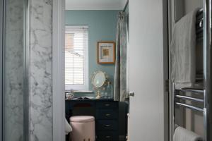 a bathroom with a sink and a toilet and a mirror at Crookes House in Weston-super-Mare