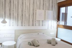 a bedroom with a bed with two pillows on it at Modern Apartment in Torrevjea 200m From the Loccos Beach in Torrevieja