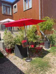 a red umbrella sitting on top of a table at Studio Chez Bob in Montreuil