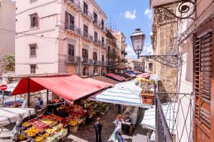 an open air market in a city with buildings at Arianna's House Historical Market in Palermo