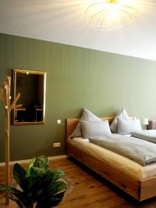 a bedroom with two beds and a mirror on the wall at Das Altschwabing - Munich Boutique Hotel in Munich