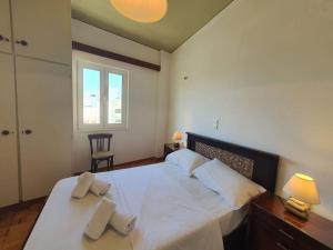 a bedroom with a large bed with two pillows on it at Cozy Small Apartment City Center in Heraklio