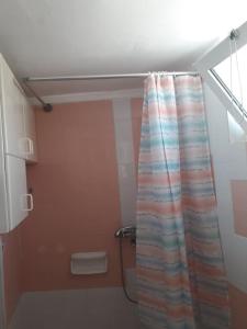 a bathroom with a shower curtain in a room at Cozy Small Apartment City Center in Heraklio