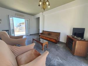 a living room with a couch and a television at Cozy Small Apartment City Center in Heraklio