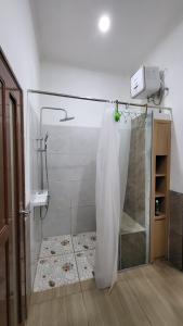 e bagno con doccia e tenda. di Rumah Tropis - Lantai 1 a Pekanbaru