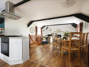 a kitchen and dining room with a table and chairs at Kielder Cottage - E3533 in Kielder