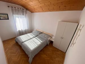 ein Schlafzimmer mit einem Bett und einem großen Fenster in der Unterkunft Apartma Magnolija in Nova Gorica