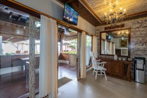 a living room with a chandelier and a table and chairs at Ketut Losmen Bungalows Lembongan in Nusa Lembongan