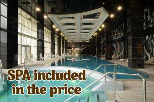 a swimming pool in a building with the words spa included in the price at ARDEN PALACE Medical Resort & SPA in Satanov