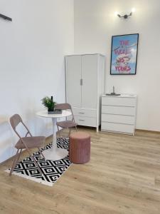 a room with a table and two chairs and a desk at DMR Apartments in Košice