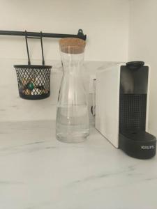 a glass vase sitting next to a microwave at Lodge avec spa au coeur de Brocéliande in Beignon