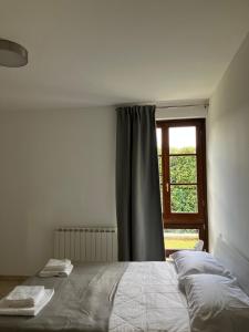 a bedroom with a bed and a window at Acero in Cortona